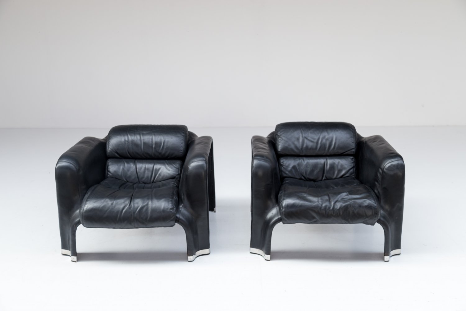 Pair of black leather Pohjola chairs by Pekka Perjo for Haimi Finland.