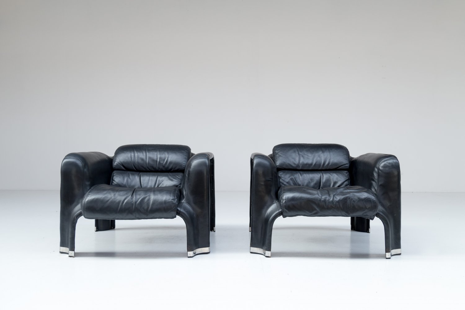 Pair of black leather Pohjola chairs by Pekka Perjo for Haimi Finland.